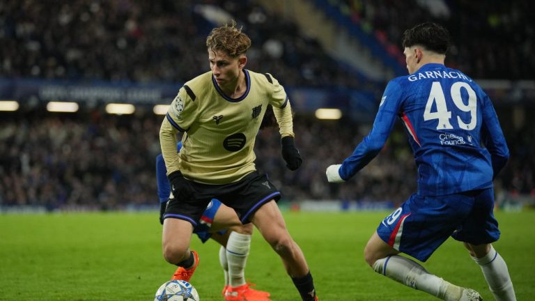 Barcelona's Fermin Lopez, left, runs with the ball past Chelsea's Alejandro Garnacho during the Champions League opening phase match between Chelsea and Barcelona in London, Tuesday, Nov. 25, 2025. (Kin Cheung/AP)