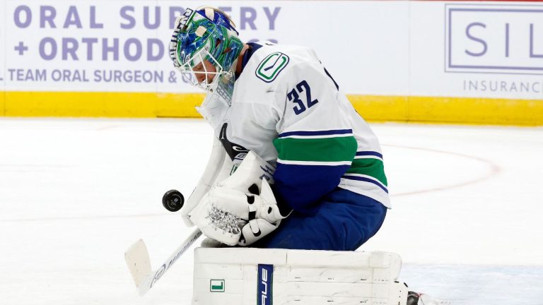 Vancouver Canucks goaltender Kevin Lankinen blocks a shot of the Carolina Hurricanes during the second period of an NHL hockey game in Raleigh, N.C., Friday, Nov. 14, 2025. (AP Photo/Karl DeBlaker)