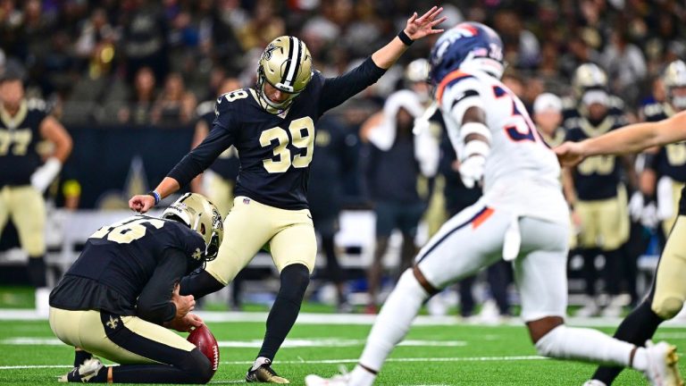 FILE - New Orleans Saints holder James Burnip, left, places the ball for place kicker Charlie Smyth to make a field goal as Denver Broncos special teams player Quinton Newsome comes in to defend in the second half of an NFL preseason football game Aug. 23, 2025, in New Orleans. (Ella Hall/AP)
