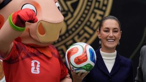 Mexican President Claudia Sheinbaum holds a soccer ball as she speaks about Mexico co-hosting the 2026 FIFA World Cup during her daily press conference at Los Pinos Cultural Complex in Mexico City, Monday, Nov. 10, 2025. (AP Photo/Marco Ugarte)