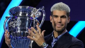 Spain's Carlos Alcaraz holds the trophy for finishing the year ranked No. 1 as ATP world best player during the ATP World Tour Finals, in Turin, Italy, Friday, Nov. 14, 2025. (AP Photo/Antonio Calanni)