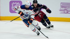 Columbus Blue Jackets center Kent Johnson (91) skates after Edmonton Oilers defenseman Jake Walman (96) in the first person of an NHL game in Columbus, Thursday, Nov. 13, 2025. (Sue Ogrocki/AP Photo)