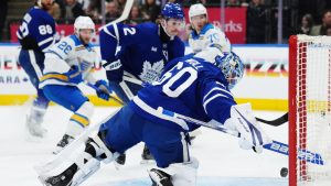 Toronto Maple Leafs goaltender Joseph Woll (60) watches the puck go in the net on a goal by St. Louis Blues' Nathan Walker (26) as Maple Leafs' Simon Benoit (2) looks on during first period NHL hockey in Toronto on Tuesday, November 18, 2025. (THE CANADIAN PRESS/Nathan Denette)
