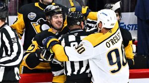 Penguin's Sidney Crosby scuffles with Predator's Ryan O'Reilly, right, during the NHL Global Series hockey game between the Pittsburgh Penguins and the Nashville Predators in Stockholm, Sweden, Sunday, Nov. 16, 2025. (Claudio Bresciani/TT News Agency via AP)