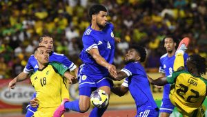 Curacao's Roshon Van Eijma, in the air, fights for the ball with Jamaica's Gregory Leigh, right, and Jonathan Russell during a World Cup 2026 qualifying soccer match in Kingston, Jamaica, Tuesday, Nov. 18, 2025. (AP Photo/Collin Reid)