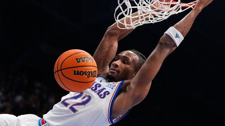 Kansas guard Darryn Peterson dunks the ball during the first half of an NCAA college basketball game against Green Bay, Monday, Nov. 3, 2025, in Lawrence, Kan. (AP Photo/Charlie Riedel)