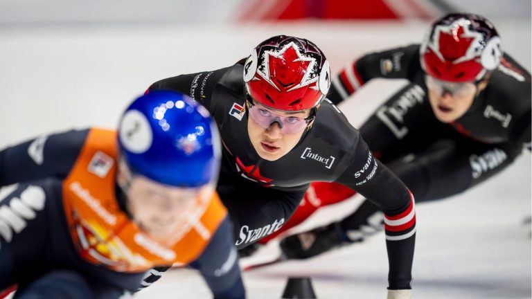 Courtney Sarault of Canada, centre, chases down Xandra Velzeboer of the Netherlands, left, during the 500m race at the ISU Short Track World Tour speed skating event in Montreal on Sunday, Oct. 19, 2025. (Christopher Katsarov/CP)