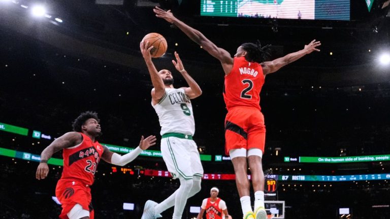 Boston Celtics guard Derrick White (9) takes a shot over Toronto Raptors forward Jonathan Mogbo (2) during the second half of a preseason NBA game, Wednesday, Oct. 15, 2025, in Boston. (AP Photo/Charles Krupa)