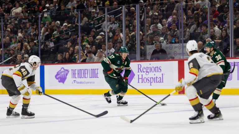 Minnesota Wild player Kirill Kaprizov, centre, controls the puck against the Vegas Golden Knights during the first period of an NHL hockey game, Sunday, Nov. 16, 2025, in St. Paul, Minn. (AP Photo/Lily Dozier)