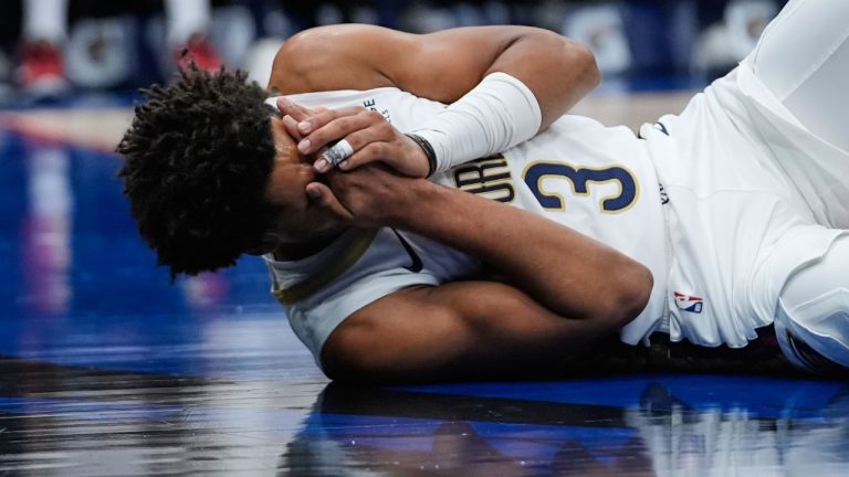 New Orleans Pelicans guard Jordan Poole lies on the court after being hit in the face in the first half of an NBA game against the Boston Celtics, Monday, Oct. 27, 2025, in New Orleans. (AP Photo/Gerald Herbert)