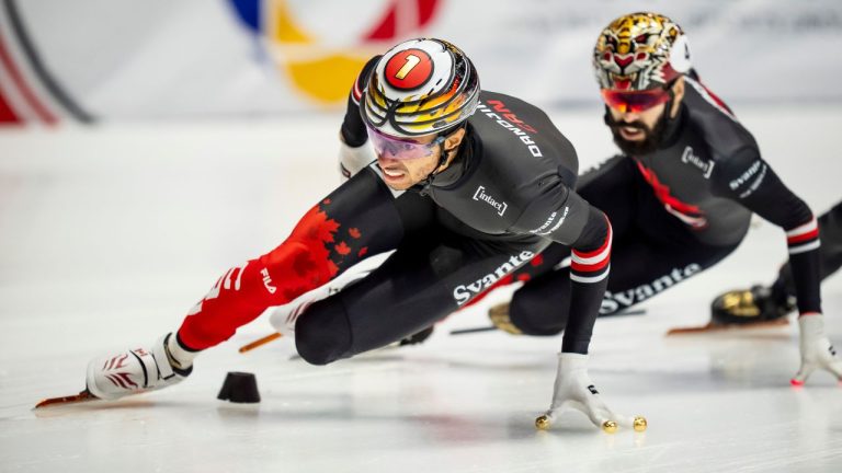 William Dandjinou of Canada skates ahead of Steven Dubois of Canada during the 500m race at the ISU Short Track World Tour speed skating event in Montreal on Sunday, Oct. 19, 2025. (Christopher Katsarov/CP)