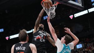 Toronto Raptors forward Brandon Ingram dunks over Charlotte Hornets centre Ryan Kalkbrenner (11) during second half NBA basketball action in Toronto on Monday, November 17, 2025. (Nathan Denette/CP)