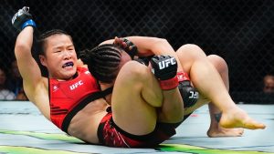 Zhang Weili grapples with an opponent during the first round of a UFC women's strawweight title bout. (Frank Franklin II/AP)