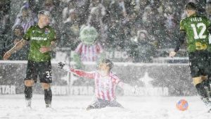 Atletico Ottawa's David Rodríguez (7) lays in the snow as he reacts to a referees, not pictured, call during second half Canadian Premier League finals soccer action in Ottawa, on Sunday, Nov. 9, 2025. (Spencer Colby/CP)
