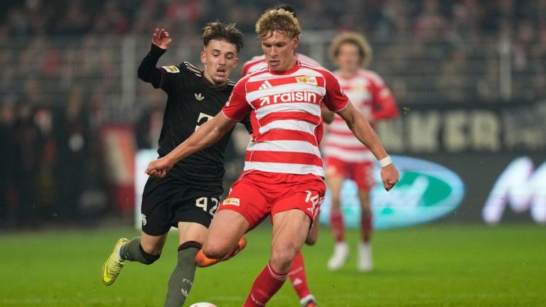 Bayern's Lennart Karl, left, Union's Leopold Querfeld challenge for the ball during the Bundesliga soccer match between Union Berlin and FC Bayern Munich in Berlin, Germany, Saturday, Nov. 8, 2025. (Martin Meissner/AP)