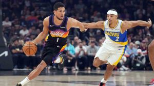 Phoenix Suns guard Devin Booker (1) drives on Indiana Pacers guard Andrew Nembhard during the first half of an NBA basketball game, Thursday, Nov. 13, 2025, in Phoenix. (Rick Scuteri/AP)