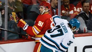 San Jose Sharks' Timothy Liljegren, right, checks Calgary Flames' Nazem Kadri during first period NHL hockey action in Calgary on Thursday, Nov. 13, 2025. (Jeff McIntosh/CP)