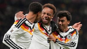 Germany's Assan Ouedraogo, centre, celebrates after scoring during a group A World Cup qualifiying soccer match between Germany and Slovakia in Leipzig, Germany, Monday, Nov. 17, 2025. (Matthias Schrader/AP Photo)