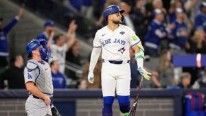 Toronto Blue Jays' Bo Bichette watches his three-run home run against the Los Angeles Dodgers during the third inning in Game 7 of baseball's World Series, Saturday, Nov. 1, 2025, in Toronto. (Brynn Anderson/AP Photo)