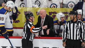 St. Louis Blues head coach Jim Montgomery questions referee Kelly Sutherland during first period NHL playoff action against the Winnipeg Jets in Winnipeg on Wednesday, April 30, 2025. (John Woods/CP)