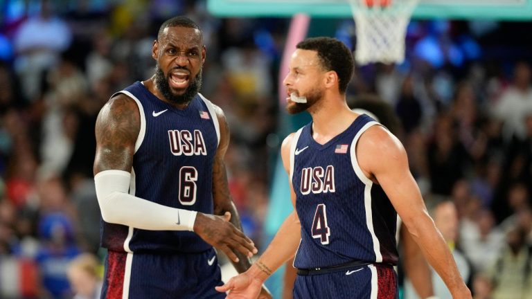 United States' LeBron James (6) and United States' Stephen Curry (4) celebrates after scoring a basket against France during a men's gold medal basketball game at Bercy Arena at the 2024 Summer Olympics, Saturday, Aug. 10, 2024, in Paris, France. (AP Photo/Mark J. Terrill)