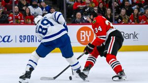 Toronto Maple Leafs left wing Nicholas Robertson (89) and Chicago Blackhawks center Colton Dach (34) fight for the puck during the first period of an NHL hockey game, Saturday, Nov. 15, 2025, in Chicago. (Matt Marton/AP)