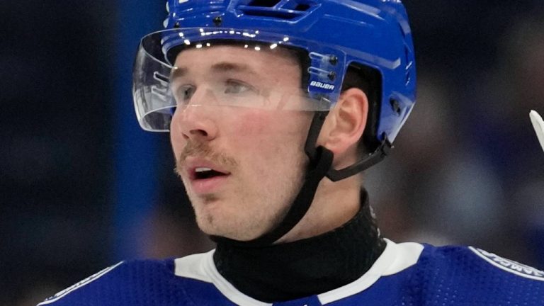 Tampa Bay Lightning left wing Cole Koepke (45) wears a protective neck guard as he talks to left wing Tanner Jeannot (84) during warms up prior to an NHL hockey game against the Boston Bruins Monday, Nov. 20, 2023, in Tampa, Fla. (Chris O'Meara/AP)