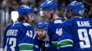 Vancouver Canucks' Filip Hronek (17), Elias Pettersson (40) and Evander Kane (91) listen to Quinn Hughes (43) before a faceoff during the third period of an NHL hockey game against the Columbus Blue Jackets, in Vancouver, on Saturday, November 8, 2025. (Darryl Dyck/CP)