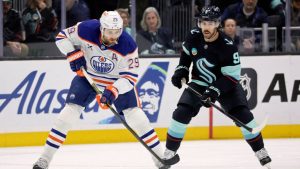 Edmonton Oilers centre Leon Draisaitl (29) controls the puck with Seattle Kraken centre Chandler Stephenson (9) defending in the first period of an NHL hockey game Saturday, Oct. 25, 2025, in Seattle. (John Froschauer/AP)