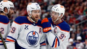 Edmonton Oilers' Connor McDavid (97) talks with Leon Draisaitl (29) during the third period of an NHL hockey game against the Carolina Hurricanes in Raleigh, N.C., Saturday, Nov. 15, 2025. (Karl DeBlaker/AP)