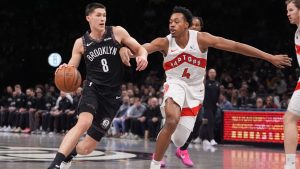 Brooklyn Nets' Egor Dëmin (8) drives past Toronto Raptors' Scottie Barnes (4) during the first half of an NBA basketball game Tuesday, Nov. 11, 2025, in New York. (Frank Franklin II/AP)
