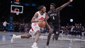 Toronto Raptors' Immanuel Quickley, left, drives past Brooklyn Nets' Drake Powell during the second half of an NBA basketball game Tuesday, Nov. 11, 2025, in New York. (Frank Franklin II/AP)