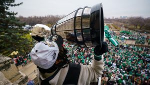 Saskatchewan Roughriders receiver Mario Alford lifts the Grey Cup on the balcony of Saskatchewan Legislative Building during a Grey Cup championship parade in Regina, Tuesday, Nov. 18, 2025. (Heywood Yu/THE CANADIAN PRESS)