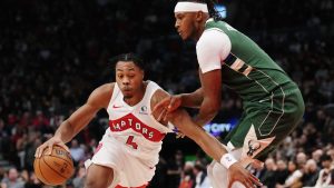 Toronto Raptors' Scottie Barnes (4) drives past Milwaukee Bucks' Myles Turner (3) during first half NBA basketball action in Toronto on Tuesday, November 4, 2025. (Nathan Denette/CP)