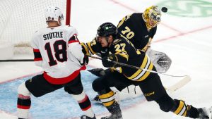 Boston Bruins' Joonas Korpisalo (70) blocks a shot as teammate Hampus Lindholm (27) defends against Ottawa Senators' Tim Stützle (18) during the third period of an NHL hockey game, Thursday, Nov. 6, 2025, in Boston. (Michael Dwyer/AP Photo)