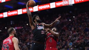 Philadelphia 76ers' Joel Embiid (21) goes up for a shot against Toronto Raptors' Scottie Barnes (4) during the first half of an NBA basketball game Saturday, Nov. 8, 2025, in Philadelphia. (Matt Slocum/AP)