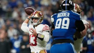 San Francisco 49ers running back Christian McCaffrey (23) passes against Indianapolis Colts defensive tackle Deforest Buckner (99) during the first half of an NFL football game, Monday, Dec. 22, 2025, in Indianapolis. (Carolyn Kaster/AP)