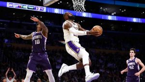 Los Angeles Lakers forward Lebron James, center, drives to the basket against Sacramento Kings guard Demar Derozan (10) as center Maxime Raynaud (42) watches during the first half of an NBA basketball game, Sunday, Dec. 28, 2025, in Los Angeles. (Jessie Alcheh/AP)