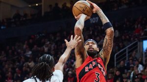 Toronto Raptors' Brandon Ingram lines up a three-point shot past Brooklyn Nets' Ziaire Williams during first half NBA action in Toronto, on Sunday, Nov. 23, 2025. (THE CANADIAN PRESS/Sammy Kogan)