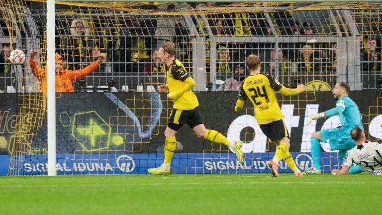 Borussia's Julian Brandt celebrates with teammates after scoring the opening goal during Germany Bundesliga soccer match between Borussia Dortmund and TSG 1899 Hoffenheim, in Dortmund, Germany, Sunday, Dec. 7, 2025. (Bernd Thissen/dpa via AP)