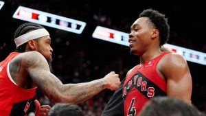 Toronto Raptors forward Brandon Ingram (3) and teammate Scottie Barnes (4) celebrate following their overtime win over the Golden State Warriors at the end of NBA basketball action in Toronto, Sunday, Dec. 28, 2025. (Frank Gunn/CP)