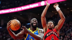 Golden State Warriors forward Draymond Green (23) drives to the net past Toronto Raptors forward Scottie Barnes (4) during first half NBA basketball action in Toronto, Sunday, Dec. 28, 2025. (Frank Gunn/CP)