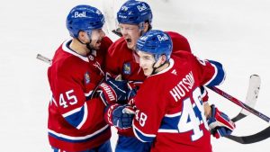 Montreal Canadiens' Zachary Bolduc celebrates his goal with teammates Alexandre Carrier and Lane Hutson during first period NHL action against the Chicago Blackhawks in Montreal on Thursday, Dec. 18, 2025. (THE CANADIAN PRESS/Christopher Katsarov)