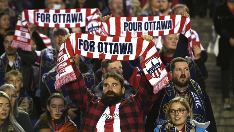 Atletico Ottawa fans raise their team's scarves before first half Canadian Premier League finals soccer action between the Atletico Ottawa and Forge FC in Ottawa on Sunday, Oct. 30, 2022. HFX Wanderers FC takes on Atletico Ottawa and York United FC faces Vancouver FC in a Canadian Championship doubleheader Wednesday at York Lions Stadium in Toronto. Atletico Ottawa is looking for its first cup win while CPL expansion side Vancouver is after its first-ever competitive victory anywhere. THE CANADIAN PRESS/Justin Tang