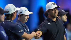 Xander Schauffele bumps fists with teammate Rickie Fowler, second left, as teammate Matt Fitzpatrick, third left, looks on, at the start of the inaugural match of the TGL indoor golf league, Tuesday, Jan. 7, 2025, in Palm Beach Gardens, Fla. (Rebecca Blackwell/AP)