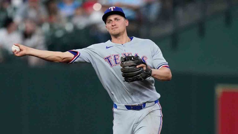 Texas Rangers shortstop Corey Seager (5) throws to first base for an out during the ninth inning of a baseball game against the Houston Astros, Friday, July 11, 2025, in Houston. (Kevin M. Cox/AP)