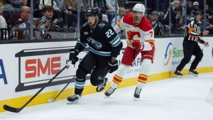 Utah Mammoth center Jack McBain (22) skates after the puck against Calgary Flames defenseman Kevin Bahl (7) during the second half of an NHL hockey game Wednesday, Oct. 15, 2025, in Salt Lake City. (Melissa Majchrzak/AP)
