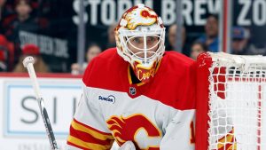 Calgary Flames goaltender Devin Cooley watches the puck against the Carolina Hurricanes during the second period of an NHL hockey game in Raleigh, N.C., Sunday, Nov. 30, 2025. (AP Photo/Karl DeBlaker)
