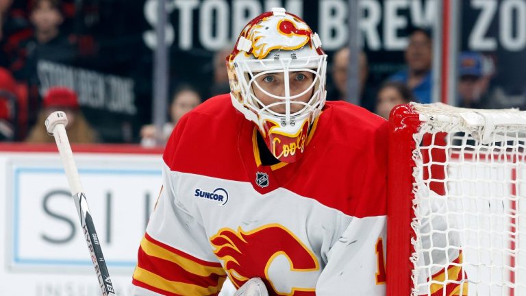 Calgary Flames goaltender Devin Cooley watches the puck against the Carolina Hurricanes during the second period of an NHL hockey game in Raleigh, N.C., Sunday, Nov. 30, 2025. (AP Photo/Karl DeBlaker)