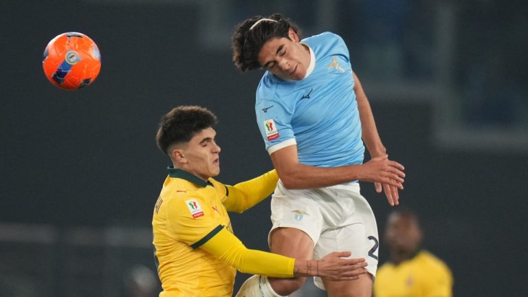 AC Milan's Davide Bartesaghi, left, and Lazio's Elseid Hysaj jump for the ball during the Italian Cup round of sixteen soccer match between Lazio and Milan, in Rome, Thursday, Dec. 4, 2025. (AP Photo/Andrew Medichini)